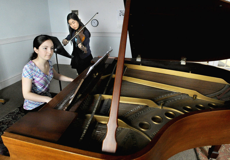 Kelia Ingraham, on piano, and Seoyeon Kim rehearse at the Portland Conservatory of Music. The two are among the nine young artists enrolled in the conservatory's Krager Scholars program.