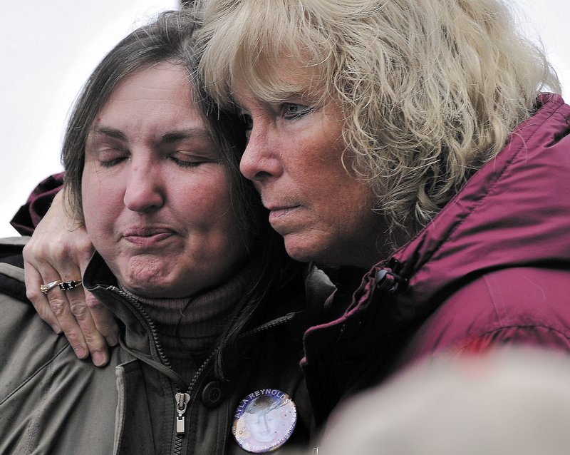 Phoebe DiPietro, left, the grandmother of missing toddler Ayla Reynolds, is comforted by Connie McCord of Waterville during the vigil in downtown Waterville on Saturday.