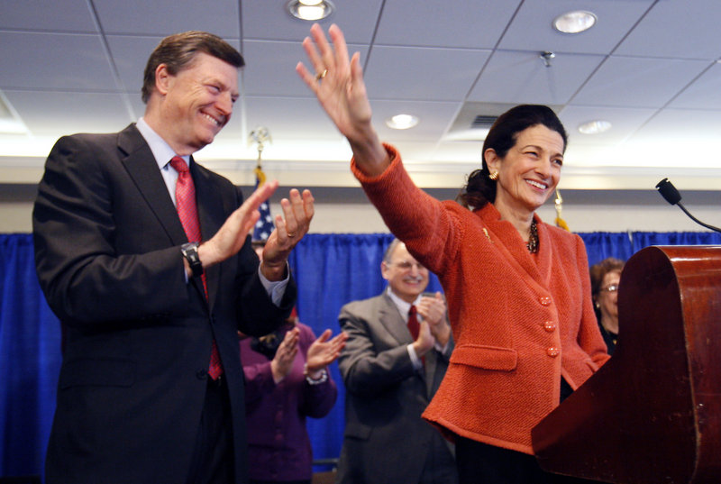 Sen. Olympia Snowe, R-Maine, accompanied by her husband, former Maine Gov. John McKernan, waves goodbye at the end of a news conference Friday in Portland. Her decision not to seek re-election to a fourth term in the U.S. Senate has transformed the state and national political narratives going into November’s election.