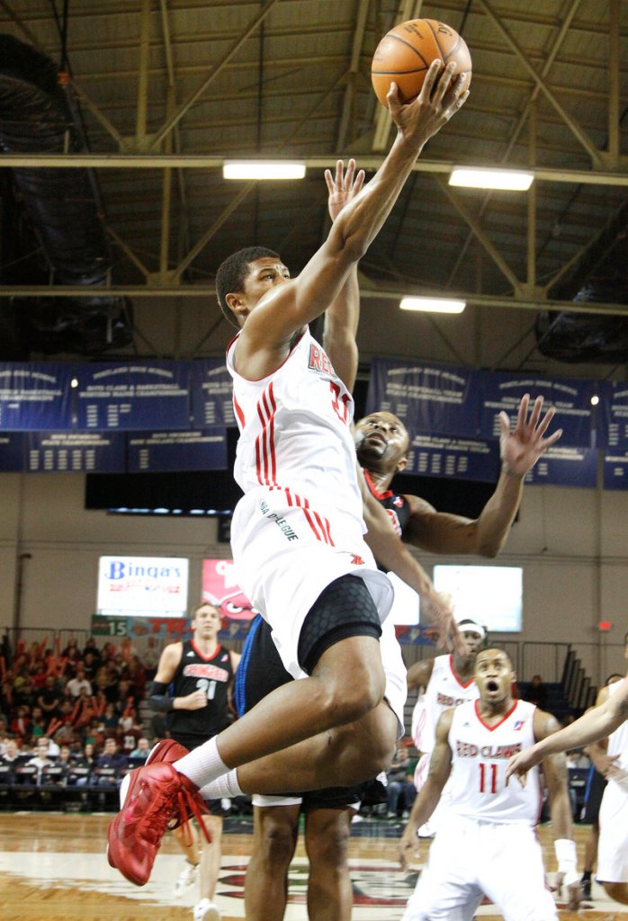 Morris Almond gets by Springfield’s Jerry Smith for a layup in Sunday’s game at the Portland Expo. Almond scored 31 points in the Red Claws’ 118-113 win.