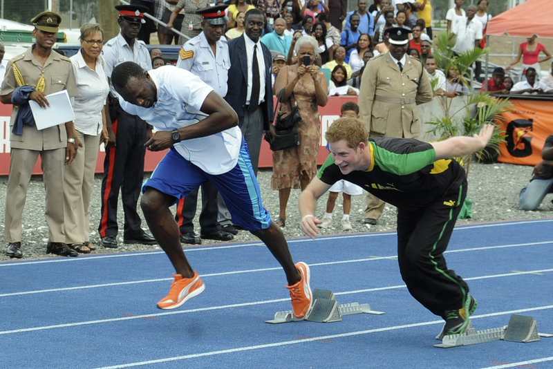 Britain's Prince Harry, right, and Olympic sprint champion Usain Bolt run a mock race in Kingston, Jamaica, on Tuesday. Harry was in Jamaica as part of a Diamond Jubilee tour.