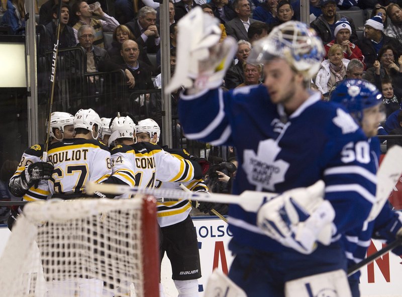 The Bruins celebrate a first-period goal Tuesday night as Leafs goalie Jonas Gustavsson looks away. The Bruins won 5-4 in Toronto to go 5-0 against the Leafs this season, outscoring them 28-10.