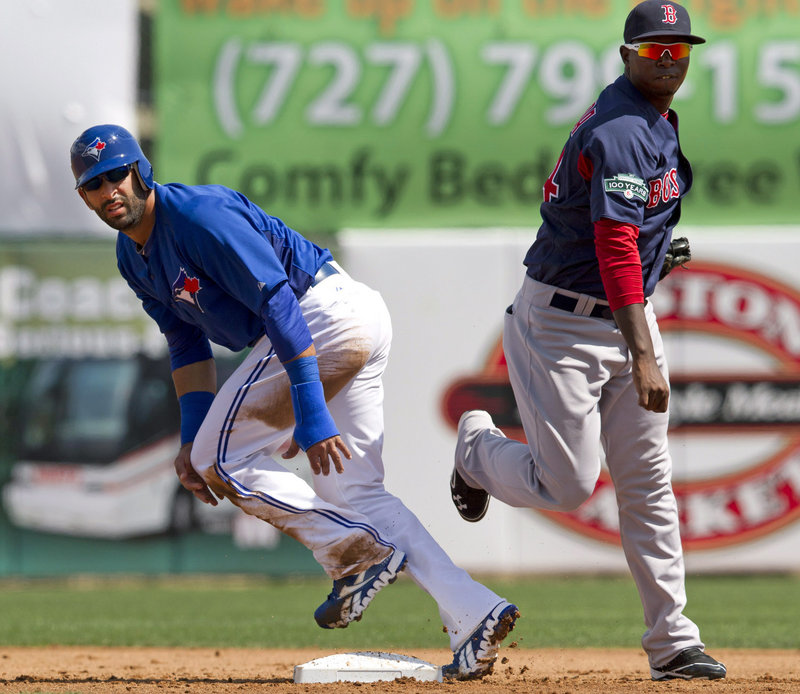 Red Sox second baseman Oscar Tejeda watches his throw to complete a double play as Jose Bautista of the Blue Jays also looks on during Wednesday’s game.