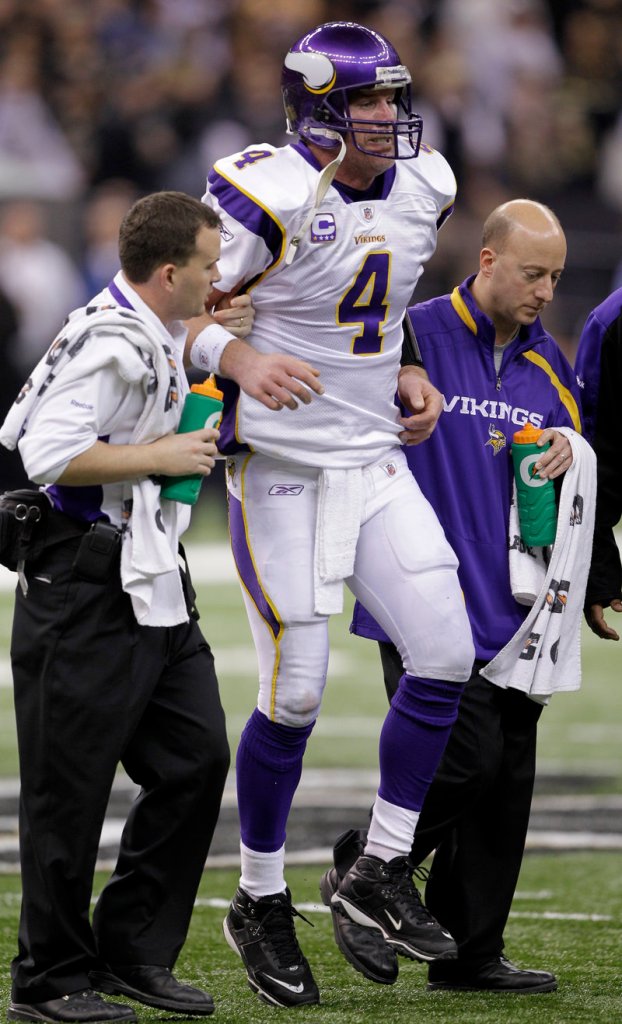 Minnesota Vikings quarterback Brett Favre is helped off the field after being hit during the NFC championship game against the New Orleans Saints in January 2010. The Saints beat the Vikings and went on to win the Super Bowl. According to an NFL investigation of bounties offered to Saints players, Favre may have been specifically targeted during that game.