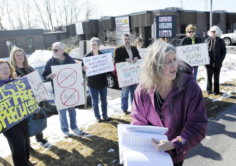 Annie Finch of Falmouth shows off the 5,700 signatures calling on radio station WGAN to stop airing the Rush Limbaugh show outside the Portland Radio Group offices Thursday.