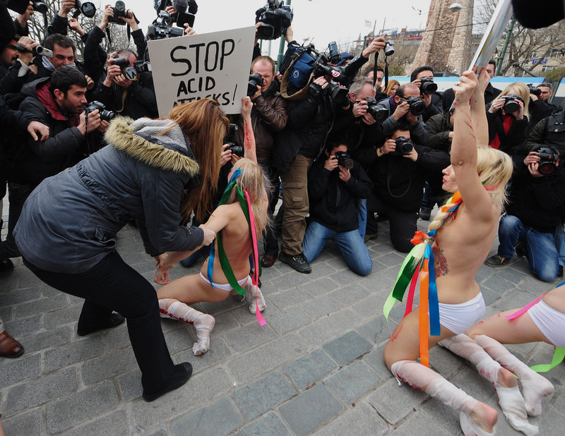 Police detain Ukrainian women’s rights activists staging a topless demonstration to protest domestic violence against women Thursday in Istanbul.