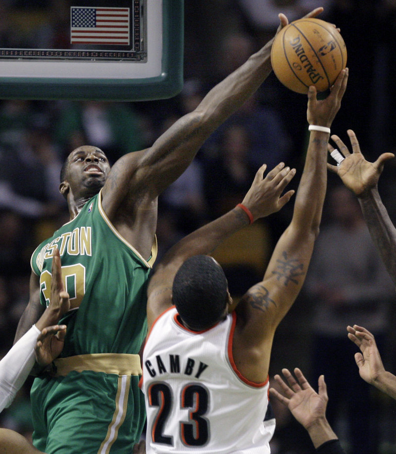 Brandon Bass of the Celtics blocks a shot by Portland Trail Blazers center Marcus Camby during the second half of their game in Boston Friday.