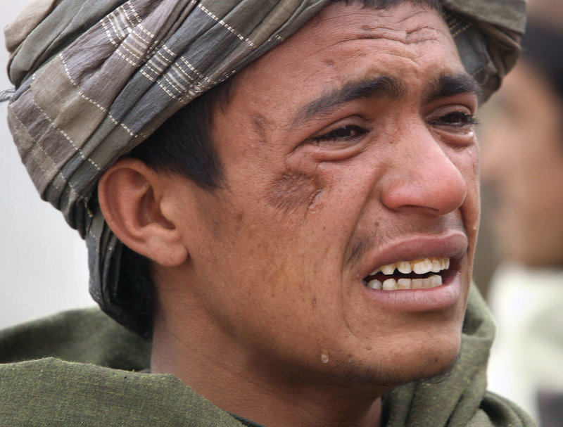 An Afghan youth mourns for relatives who were allegedly killed by a U.S. service member in Panjwai, Kandahar province, Afghanistan, on Sunday.