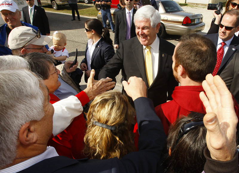 Republican presidential candidate and former House Speaker Newt Gingrich campaigns outside Mama Lou’s restaurant in Robertsdale, Ala., on Saturday.