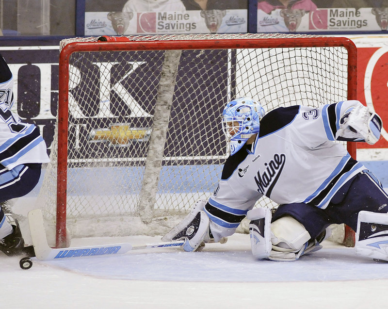 Dan Sullivan makes a stick save as the puck rolls toward the net during Sunday’s game at Alfond Arena. UMaine is trying to reach the NCAA tourney for the first time since 2007.