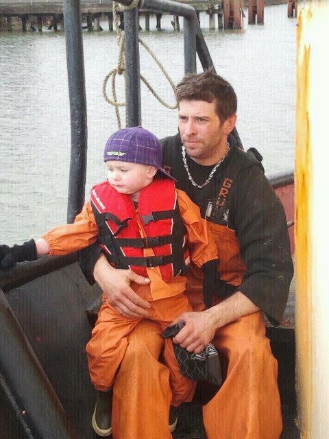 Jason Bjaranson is shown with his son, Talon, in 2011. Bjaranson – along with another deckhand, the vessel's skipper and a NOAA Fisheries Service observer – was aboard the Lady Cecelia, a fishing vessel that sunk off southern Washington state this weekend. The Coast Guard found no survivors.