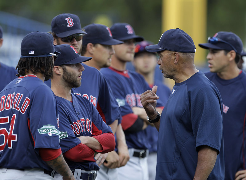 Dustin Pedroia, the Red Sox second baseman, talks with Hall of Famer Reggie Jackson prior to Boston’s spring training game with the New York Yankees on Tuesday. The Red Sox won, 1-0.
