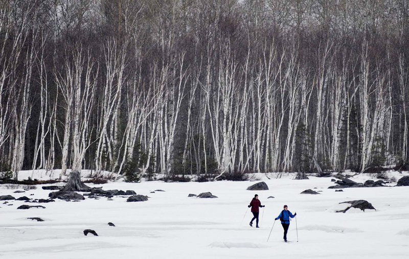 Tricia Deering, left, and Linda Laird, both of New Jersey, ski across a section of Flagstaff Lake with birch trees as their backdrop. The two were part of a four-person group that took advantage of Maine Huts and Trails, which is bringing enthusiasts to the outdoors of western Maine.