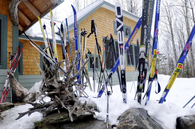 Skis and driftwood line the walkway outside the Flagstaff Lake Hut.