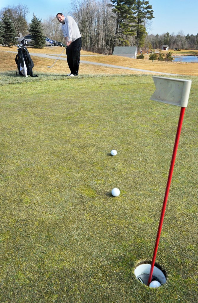 Seth Francis of Portland works on his short game Thursday at Nonesuch River Golf Club in Scarborough. Across southern Maine, the golf season has started early.