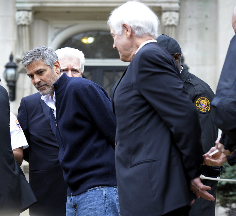Actor George Clooney, center, Rep. Jim Moran, D-Va., back, and Clooney’s father, Nick Clooney, right, are arrested during a protest at the Sudanese Embassy in Washington on Friday. Earlier, Clooney spoke out against the violence in Sudan.