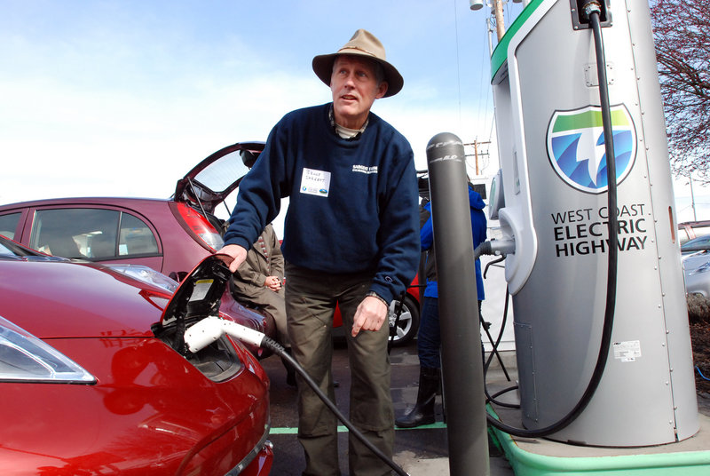 Bruce Sargent of Ashland, Ore., tops off the charge on his Nissan Leaf on Friday at a new electric car charging station in Central Point, Ore. The station is one of eight along a 160-mile section of Interstate 5.
