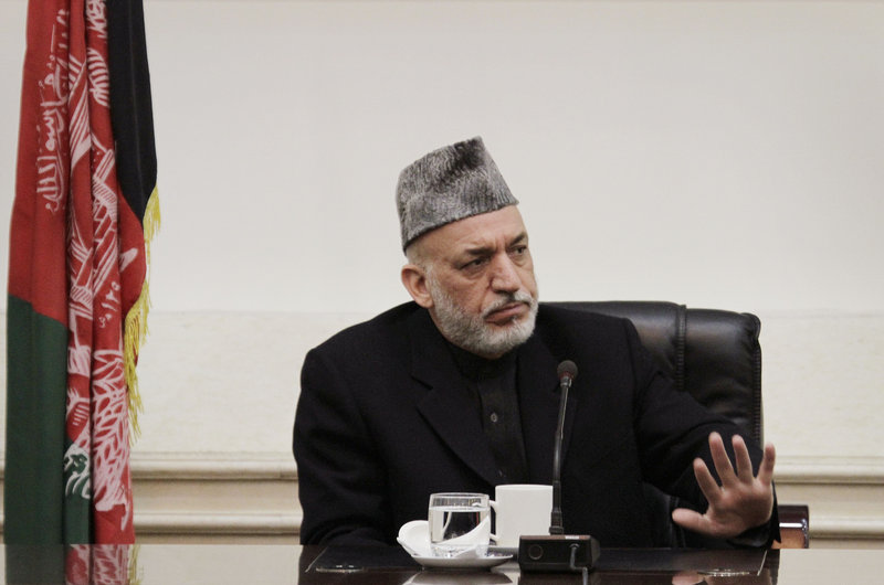 Afghan President Hamid Karzai listens to family members of last Sunday’s massacre.