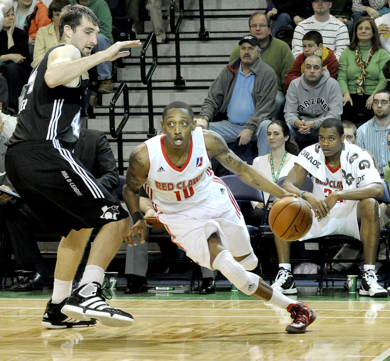 Kenny Hayes of the Maine Red Claws finds room along the baseline to drive against Luke Zeller of the Austin Toros at the Portland Expo. The Red Claws suffered a 119-112 loss.