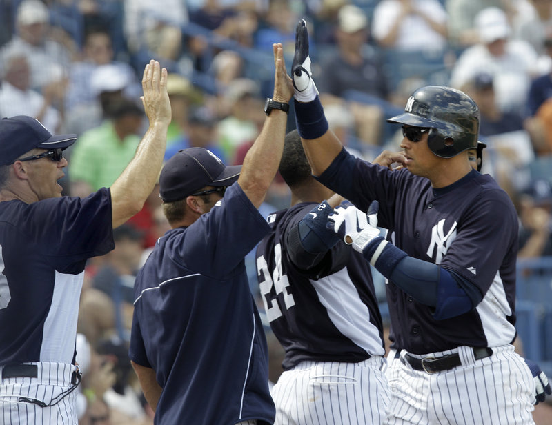 Alex Rodriguez, right, is greeted by Yankees Manager Joe Girardi, left, and hitting coach Kevin Long after hitting a two-run homer Friday against the Washington Nationals. The Yankees won 4-3 in 10 innings at Tampa, Fla.