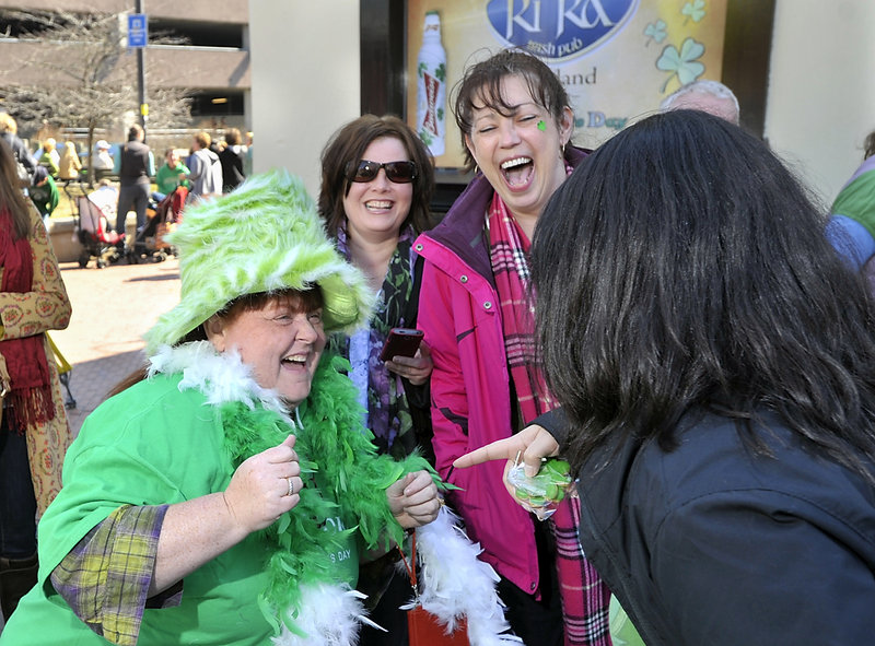 Liz Meserve of Portland entertains her friends as she celebrates St. Patrick’s Day. She is standing in line at Ri Ra after having a corned beef and cabbage breakfast at Brian Boru on Saturday.