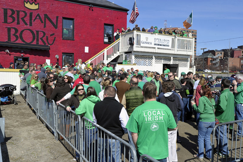 A packed crowd, conspicuous in green, enjoys the sunshine outside of Brian Boru in Portland as they enjoy the festivities on St. Patrick’s Day. The restaurant opened at 6 a.m. and served an Irish breakfast that included corned beef and cabbage.