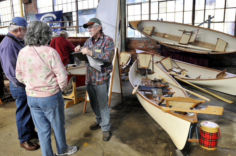 Steve Kaulback, founder of Adirondack Guideboat Inc. out of Charlotte, Vt., talks with visitors at the Maine Boatbuilders Show.