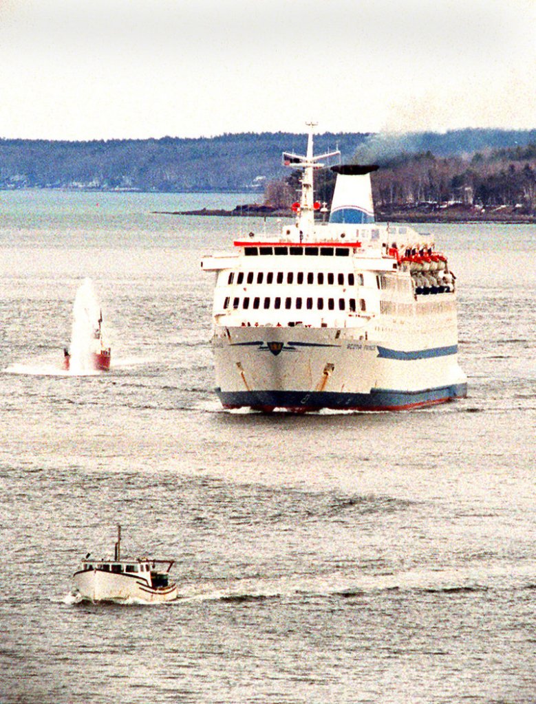 The Scotia Prince cruises into Portland Harbor with a fireboat escort to dock at the International Marine Terminal in April 2001.