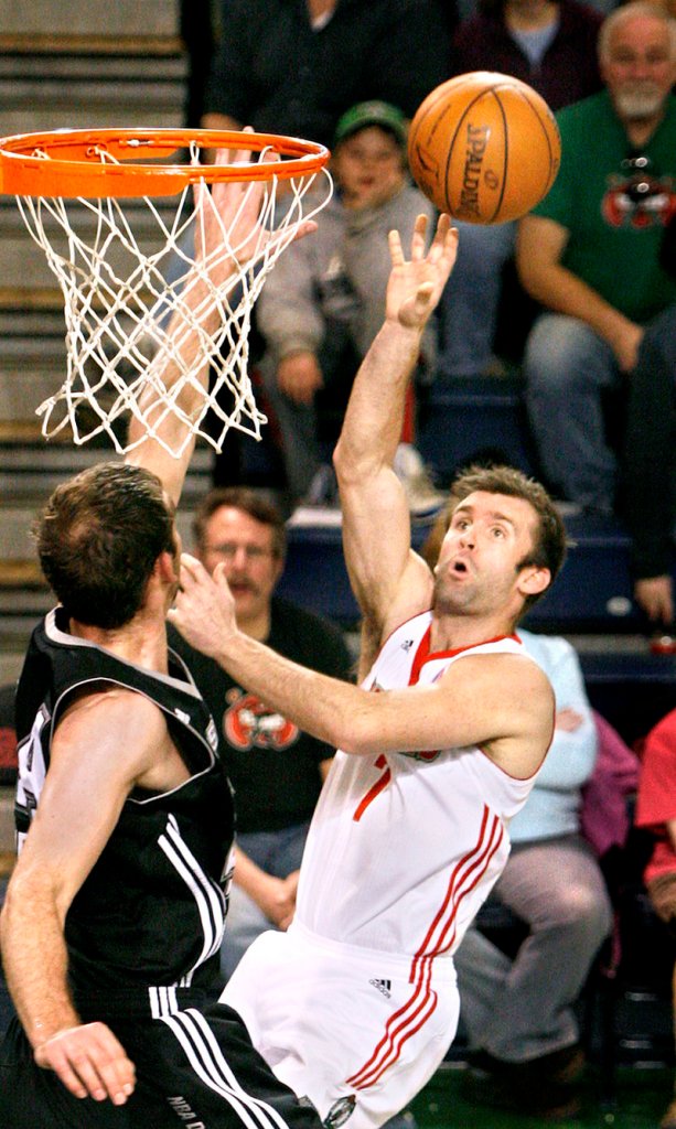 Mike Gerrity of the Red Claws shoots over Luke Zeller of the Austin Toros in the first half of their game Sunday at the Portland Expo.
