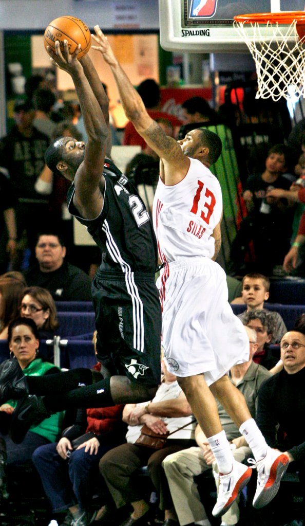 Xavier Silas of the Red Claws tries to block the shot of Julian Wright of the Toros during Sunday’s game at the Portland Expo. The Toros won easily.