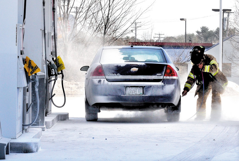 A firefighter responds to the Irving Circle K gas station on Route 201 in Skowhegan on Sunday, after a cloud of fire-suppression powder was emitted from about 50 hoses installed in the roof of the fuel-pumping area. The chemical covered vehicles, people and the station’s parking lot.