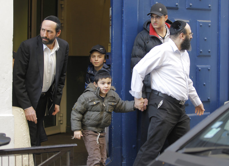 French schoolchildren leave a Jewish school in Paris on Monday, after the French interior minister ordered security to be tightened around all French Jewish schools following an attack on one in Toulouse. A father and his two sons were among four people who died.