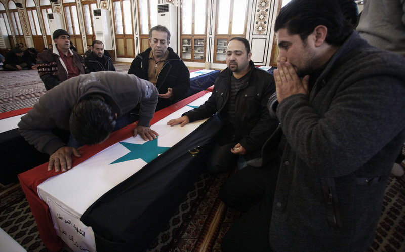 Mourners attend a funeral on Sunday for a victim of a suicide bomb attack in Damascus, Syria.