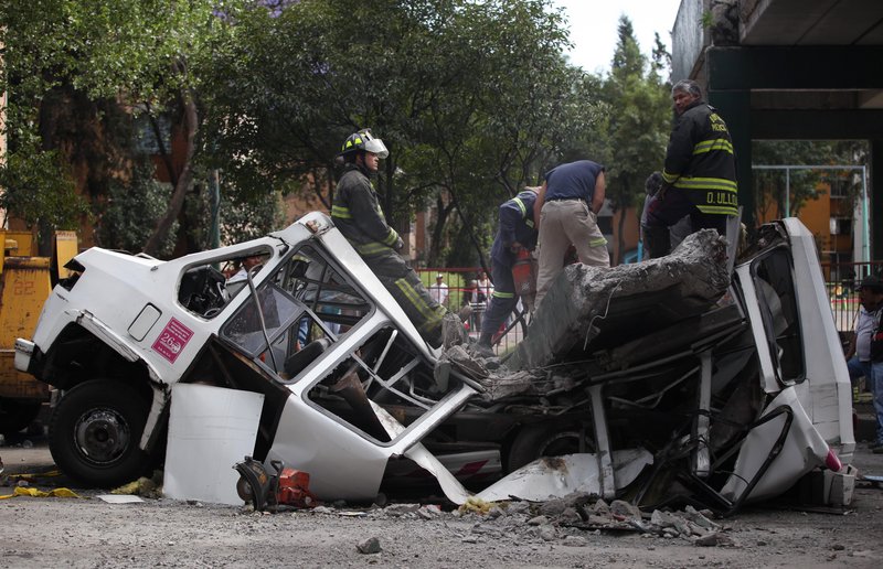 In Mexico City, earthquake damage included a pedestrian bridge that collapsed on an empty transit bus.