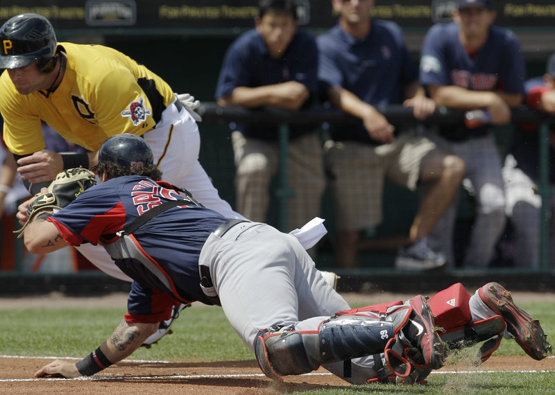 Red Sox catcher Jarrod Saltalamacchia lunges to tag out Matt Hague of the Pittsburgh Pirates, who was trying to score on a fielder’s choice Wednesday. Pittsburgh won, 6-5.