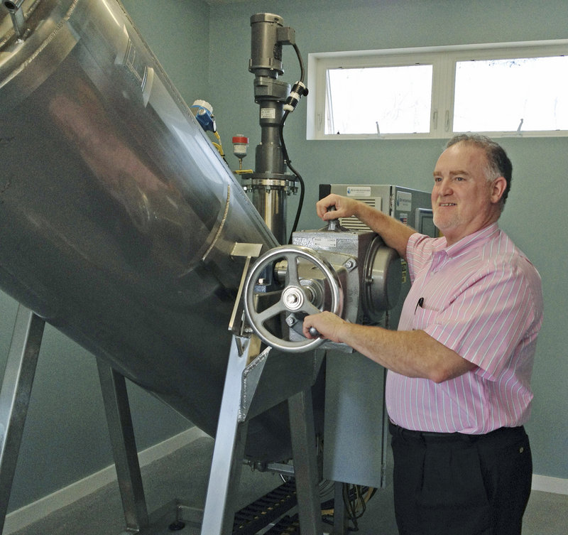 Mark Riposta, owner of Direct Cremation of Maine, stands with his new alkaline hydrolysis system. His business is one of the few commercial crematories in the U.S. using the system.