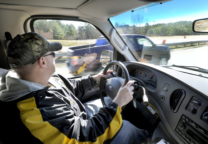 Maine State Police Trooper Steven Stubbs spots a driver using his cellphone and speeding as Stubbs and fellow Trooper Michael Cook patrol the Maine Turnpike in an unmarked van looking for drivers who are texting Thursday morning. The driver was issued a ticket.