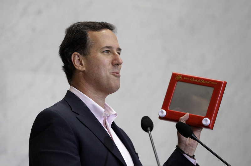 Former Sen. Rick Santorum holds an Etch A Sketch as he speaks to USAA employees during a campaign stop Thursday in San Antonio.