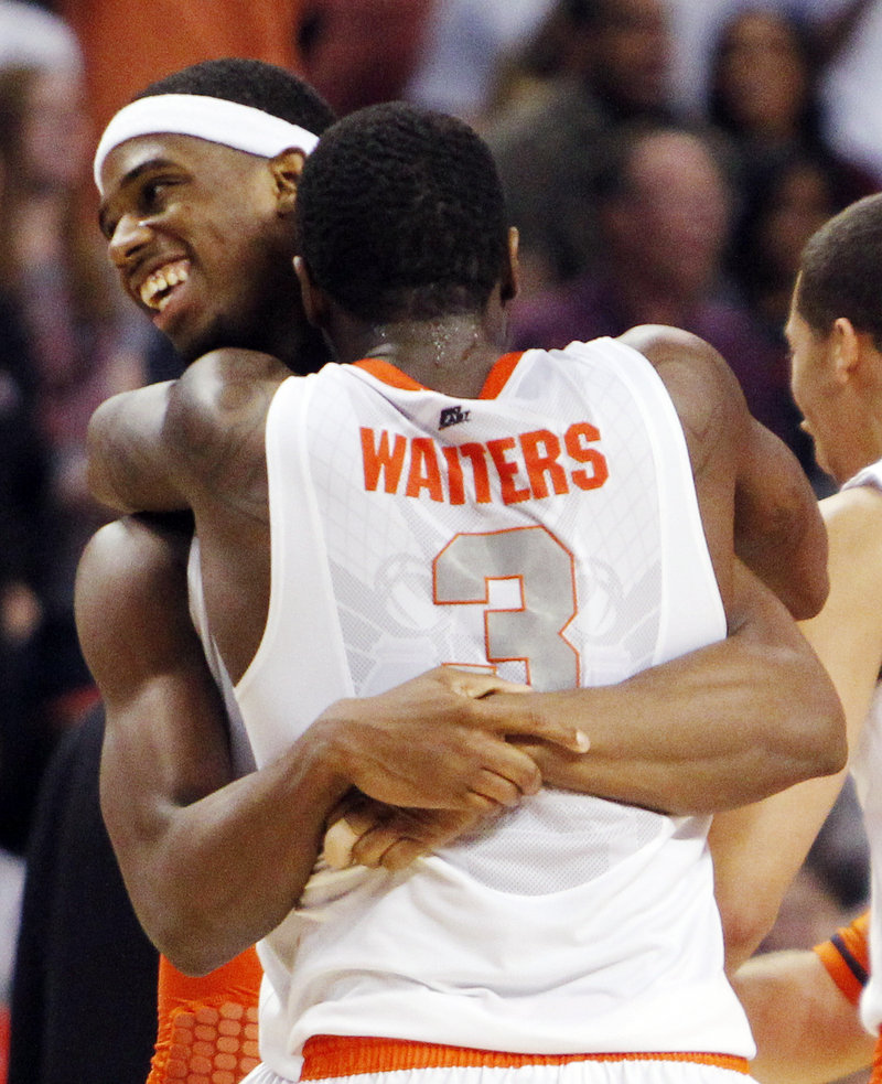 Dion Waiters and C.J. Fair embrace Thursday night after Syracuse moved within one victory of reaching the Final Four by holding on to a 64-63 victory against Wisconsin in the East Regional semifinals at Boston.