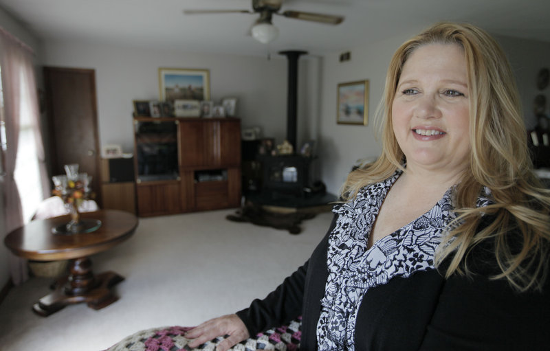 Michelle Chesney-Offutt is shown in her home before leaving for work as an insurance customer service representative in Sandwich, Ill. Chesney-Offutt, who was unemployed for nearly three years, said a recruiter who responded to her online resume two years ago backed off when he learned she had been jobless for 13 months.