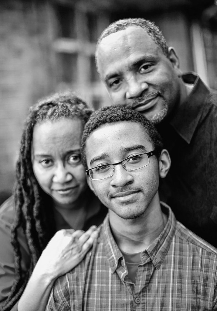 Jeanne and Paul Miller with their son, Jeremy, 16, in front of their home in Flossmoor, Ill. The Millers cautioned Jeremy before he entered his teens that some people would view him with suspicion because of his race.