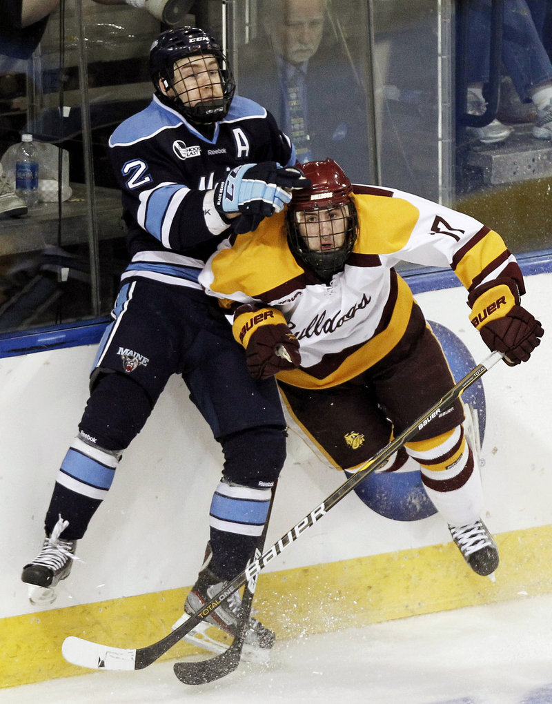 Mike Cornell of UMaine collides with Minnesota-Duluth’s Mike Seidel during the second period Saturday night in Worcester, Mass. Minnesota-Duluth rallied for a 5-2 win to end UMaine’s season.