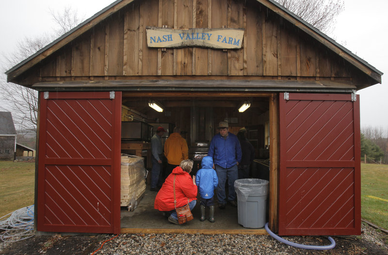 Heidi Donnelly of Scarborough and her son Gehrig, 4, visit the sugarhouse at Nash Valley Farm in Windham on Maine Maple Sunday. Although the farm produced close to 100 gallons of syrup in 2011, this year it made only 40 gallons.