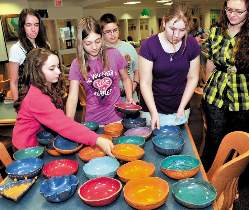 Skowhegan Area Middle School students unpack some of the 100 clay bowls they made for a fundraiser to benefit local food banks. From left are Marinel Demmons, in back, Samantha Joy, Elizabeth Jones, Andrew Todd, Mariah Bonneau and potter Yvonne Ballenbacher.