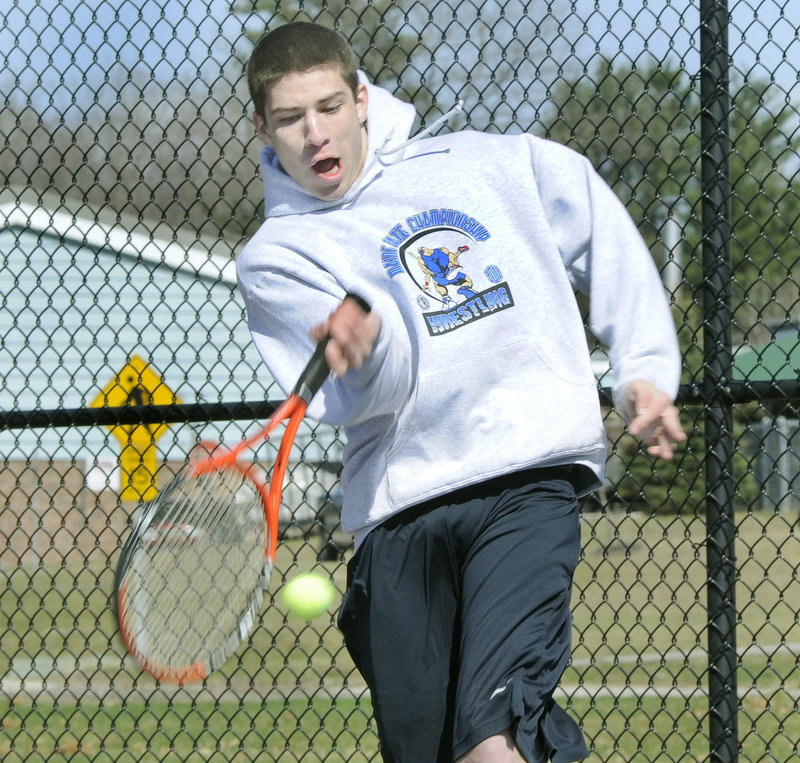 Devin Pelletier, one of Windham's top doubles players last year, hits a shot during the opening practice session.