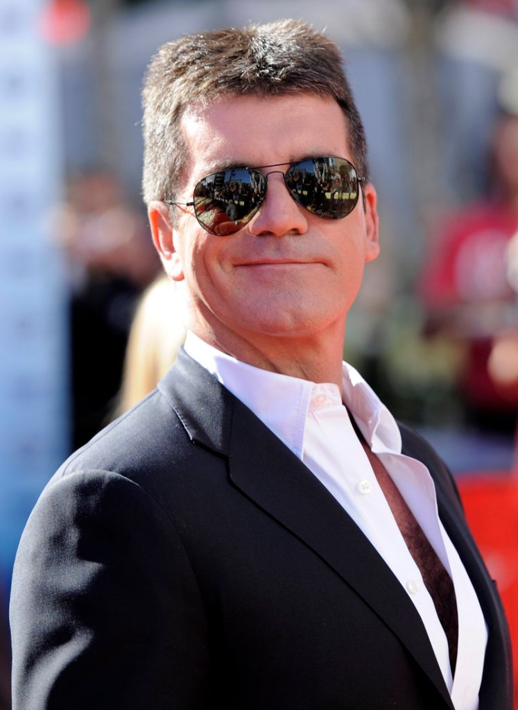Prosecutors said Simon Cowell was watching TV in the bedroom of his London mansion Saturday night when he heard a loud bang coming from his bathroom and discovered a woman inside with a brick.
