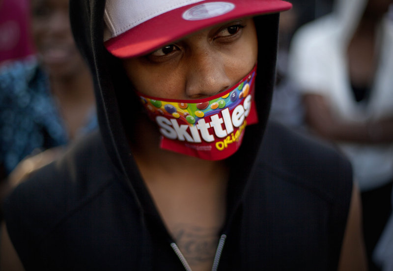 Jajuan Kelley of Atlanta wears a Skittles wrapper over his mouth during a rally Monday in Atlanta in memory of Trayvon Martin, who was killed in Florida while returning from a convenience store with a bag of Skittles and an Arizona iced tea.