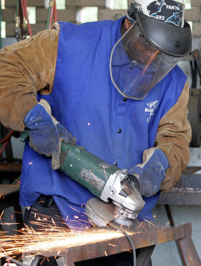 A student uses a grinder during welding class at Midlands Technical College in Columbia, S.C. Manufacturing has become complex, and so has the mathematics involved.