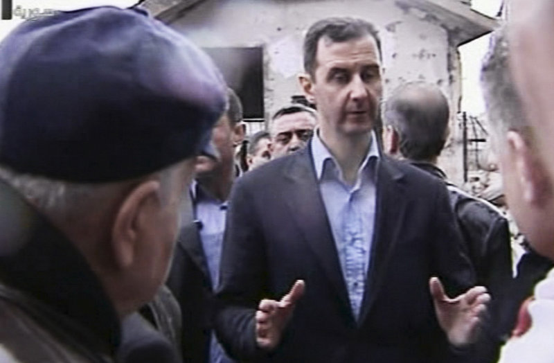 In an image made from video, Syrian President Bashar Assad visits the Baba Amr neighborhood, a former rebel stronghold in Homs, on Tuesday. Government forces now control Homs.