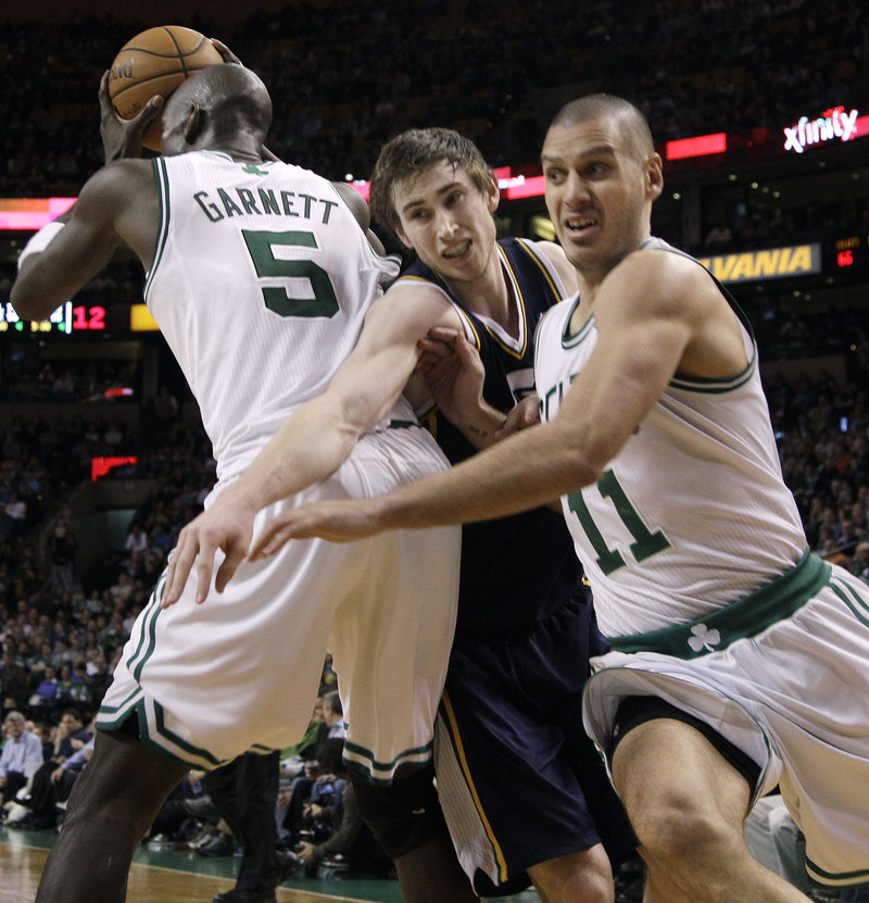 Sasha Pavlovic of the Boston Celtics heads to the basket Wednesday night as Gordon Hayward of Utah attempts to fight through a pick by Kevin Garnett, who has the ball.